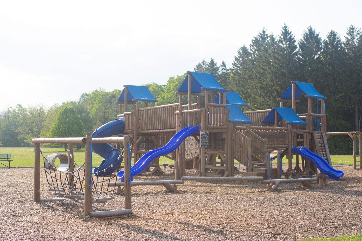 Playground: Large wooden playground with blue canopies and slides