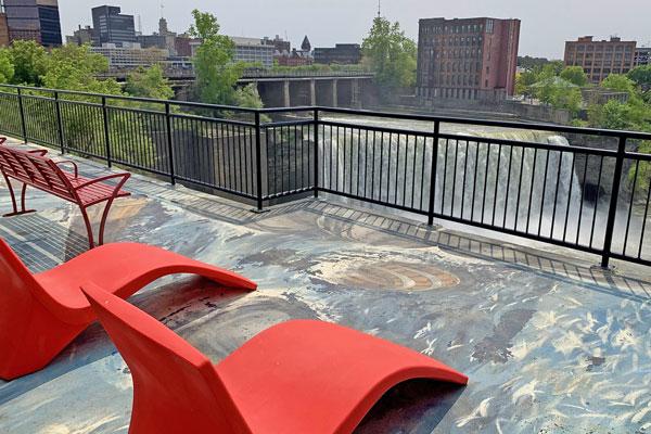 Look over the railing at the High Falls of Rochester.