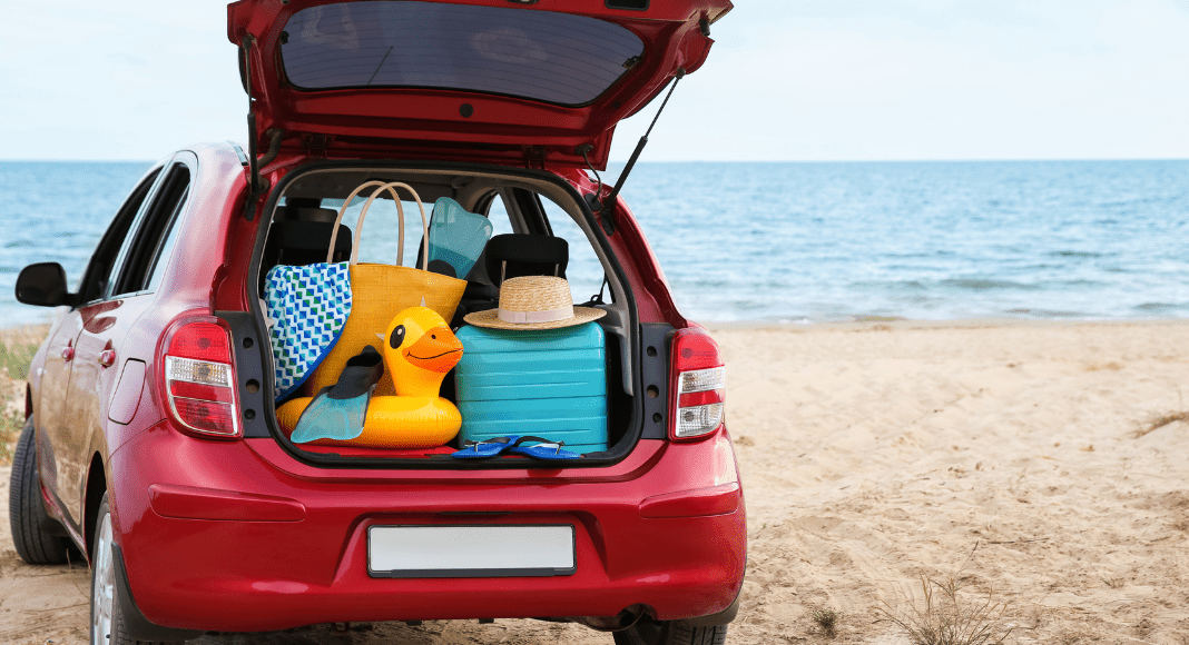 A packed car sits at the beach