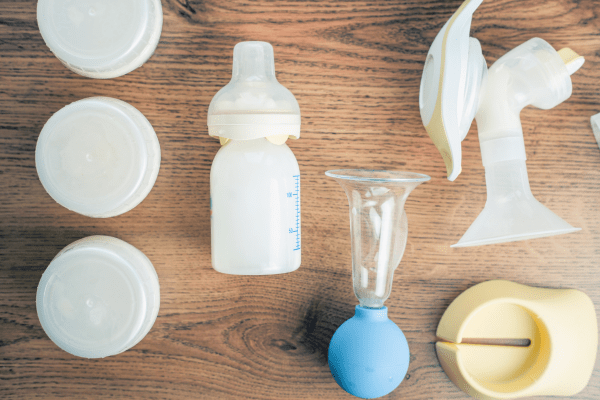 Miscellaneous breast pumping parts sit on a table