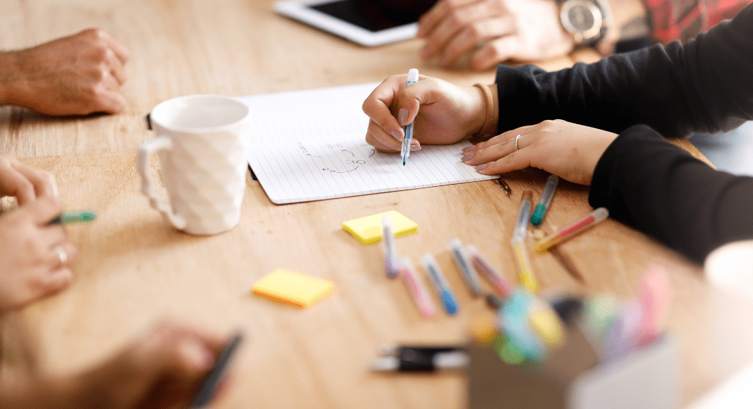 A table at a meeting with office supplies