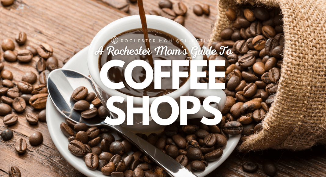 Dark coffee is poured into a white cup with coffee beans spilled around in our Guide To Rochester Coffee Shops.