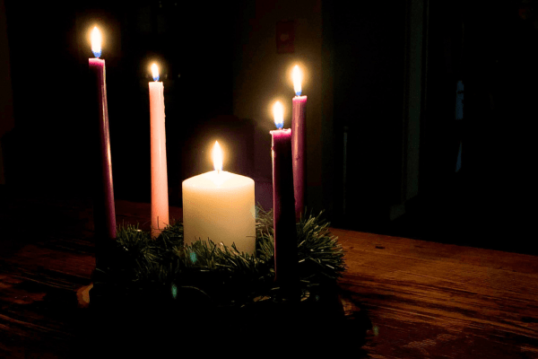 Candles are all lit on an advent wreath.