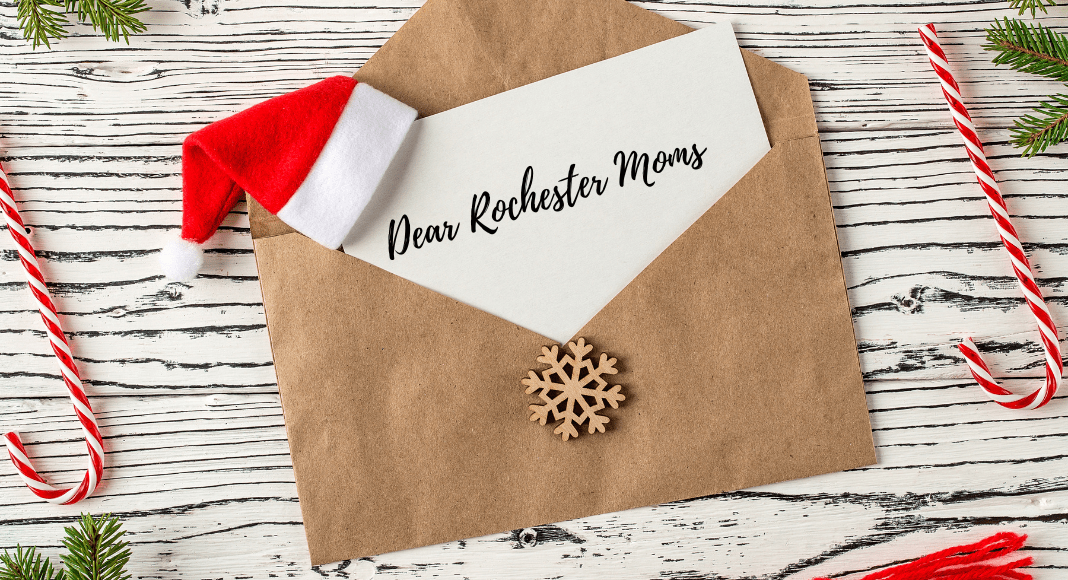 A letter on a table with candy canes and greenery.