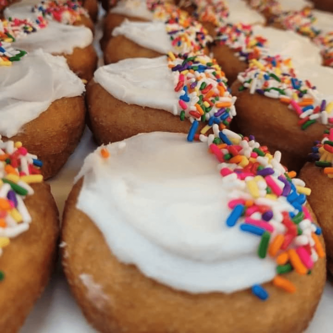 Vanilla Frosted donuts with rainbow sprinkles.