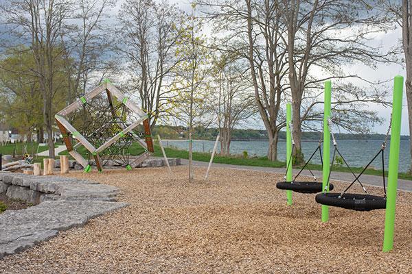 A playground and walking path along a path by Lake Ontario at Sandbar Park in Webster.